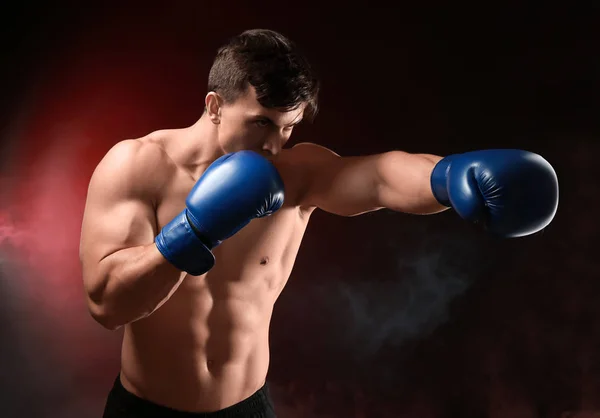 Attractive young boxer on dark background — Stock Photo, Image