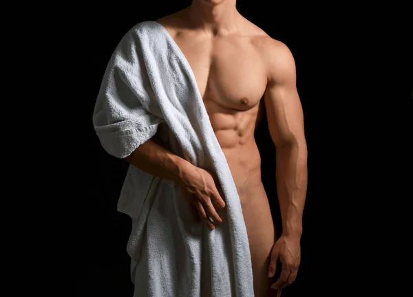 Muscular fisiculturista sexy com toalha no fundo escuro — Fotografia de Stock