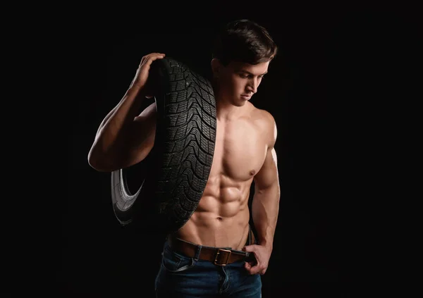Muscular auto mechanic on dark background — Stock Photo, Image