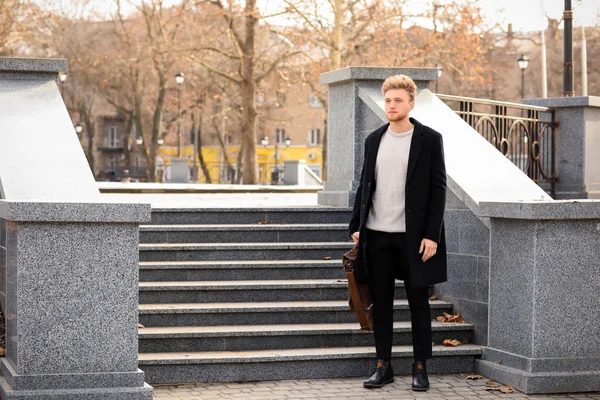 Businessman with stylish briefcase near stairs outdoors