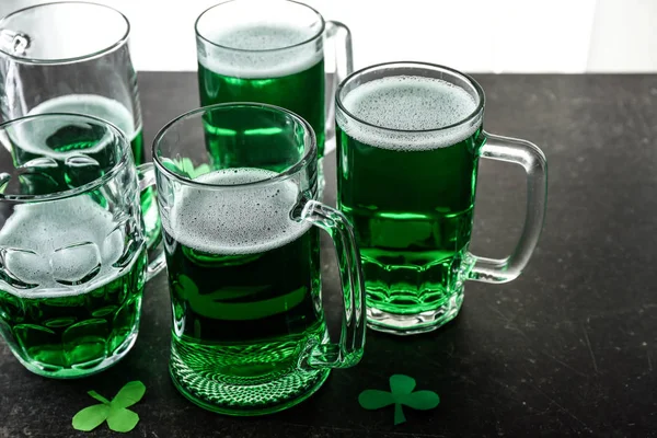Mugs of green beer on table. St. Patrick's Day celebration — Stock Photo, Image