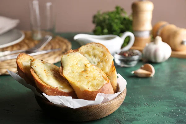 Sliced bread with garlic and cheese on table — Stock Photo, Image