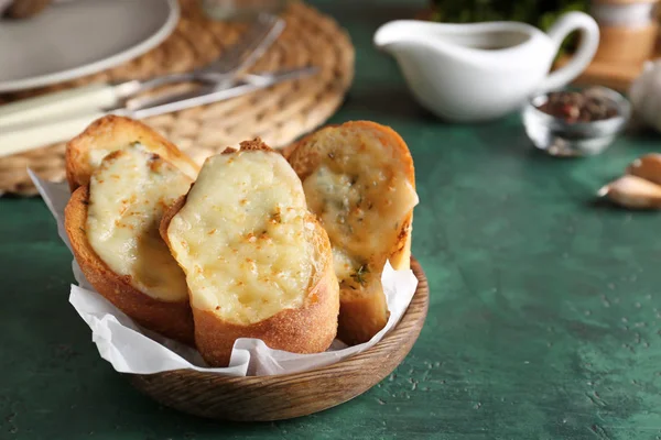 Sliced bread with garlic and cheese on table — Stock Photo, Image