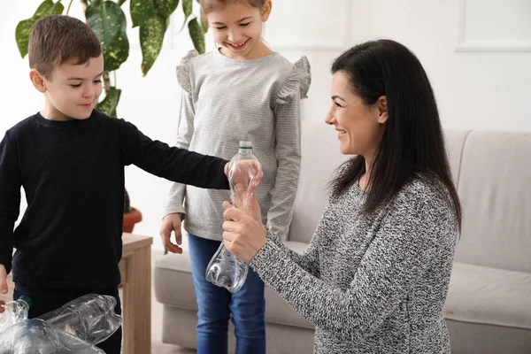 Family with plastic bottles at home. Concept of recycling — Stock Photo, Image