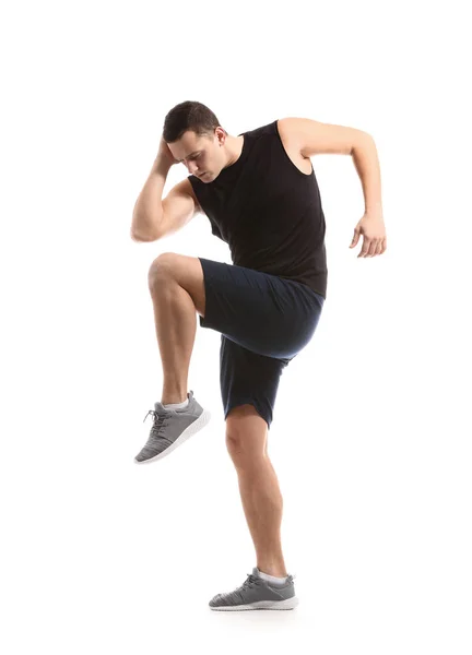 Sporty young man training against white background — Stock Photo, Image