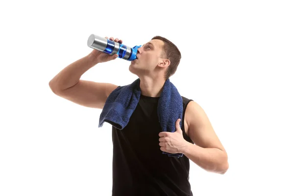 Sporty young man with bottle of water against white background — Stock Photo, Image