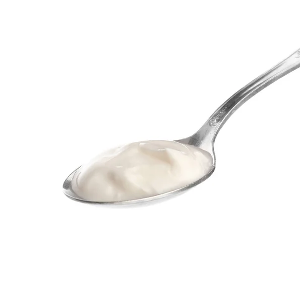 Colher com iogurte saboroso no fundo branco — Fotografia de Stock