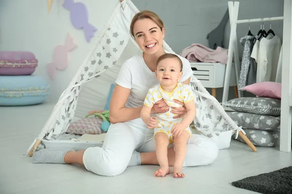 Mother with cute baby girl at home — Stock Photo, Image