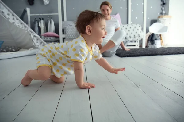 Cute baby girl crawling on floor — Stock Photo, Image