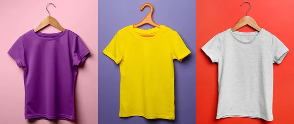 Camisetas de criança diferentes no fundo de cor — Fotografia de Stock