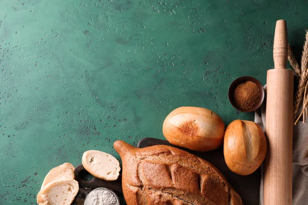 Assortment of fresh bread on color background — Stock Photo, Image