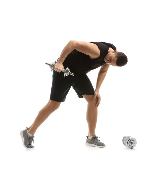 Sporty young man training with dumbbells against white background — Stock Photo, Image