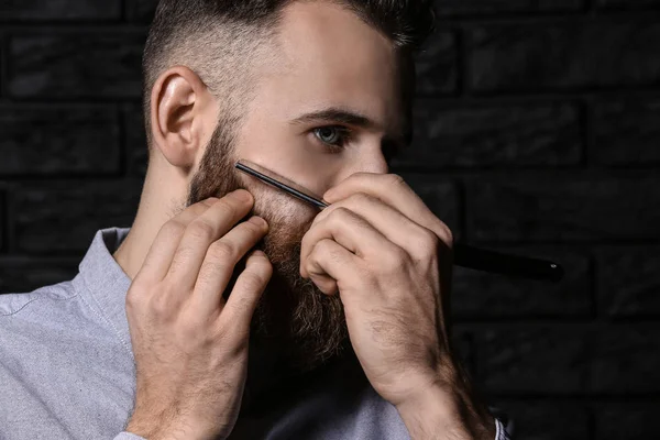 Barbudo hombre afeitándose sobre fondo oscuro — Foto de Stock