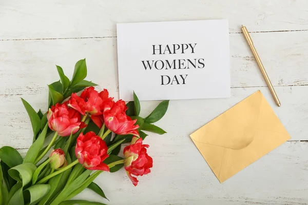Composición con hermosas flores y tarjeta de felicitación para el 8 de marzo en mesa de madera blanca — Foto de Stock