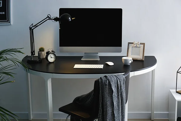 Stylish workplace with modern computer near light wall — Stock Photo, Image