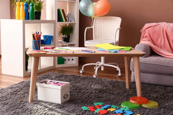 Wooden table in stylish interior of kid room — Stock Photo, Image