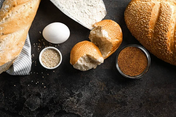 Bakery products with ingredients for dough on grey background — Stock Photo, Image