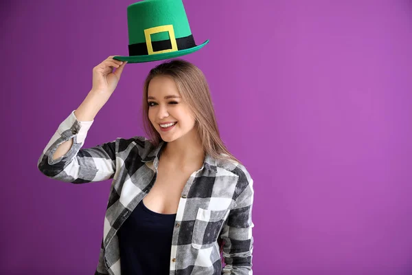 Bella giovane donna con cappello verde su sfondo a colori. Festa di San Patrizio — Foto Stock
