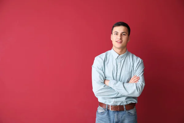 Portrait of young businessman on color background