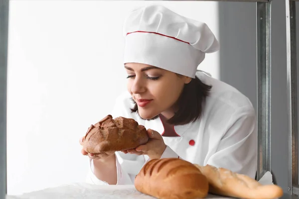 Θηλυκό σεφ με φρεσκοψημένο ψωμί στην κουζίνα — Φωτογραφία Αρχείου