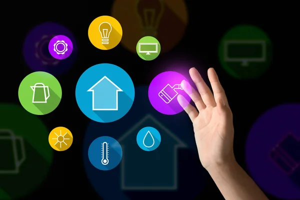 Young woman using futuristic interface of smart home automation on dark background — Stock Photo, Image