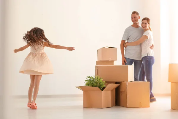 Happy family with cardboard boxes after moving into new house — Stock Photo, Image