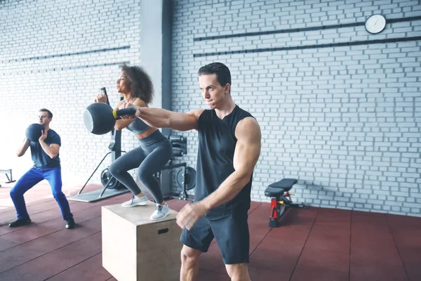 Group of athletes working out in gym — Stock Photo, Image