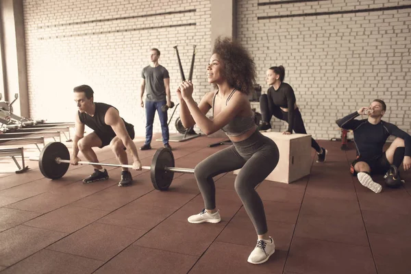 Group of athletes working out in gym — Stock Photo, Image