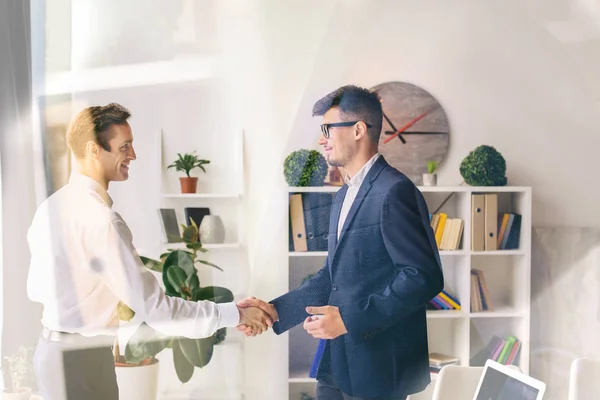 Men shaking hands during business meeting in office, view through glass — Stock Photo, Image