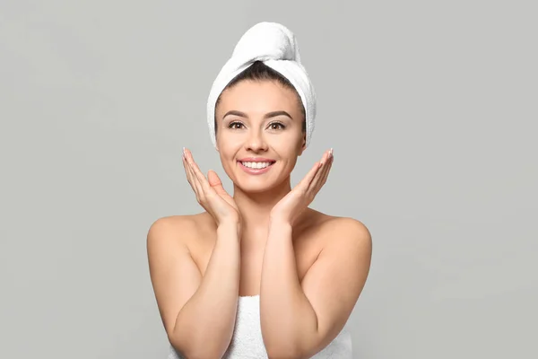 Beautiful young woman with silky skin after spa treatment on light background — Stock Photo, Image