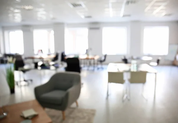 Blurred view of office interior with tables and armchairs. Workplace design — Stock Photo, Image