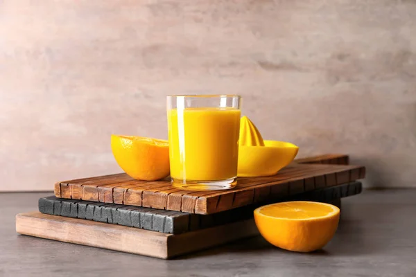 Glass with fresh citrus juice on table — Stock Photo, Image