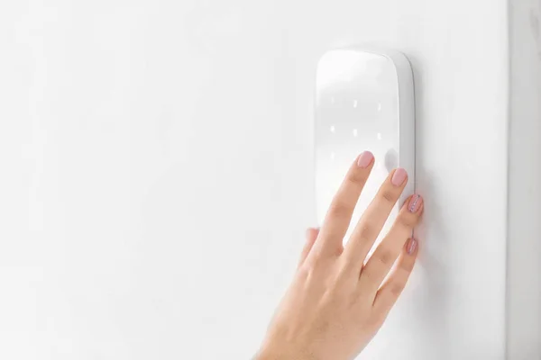 Young woman using security system indoors — Stock Photo, Image