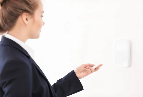 Young woman using security system indoors — Stock Photo, Image