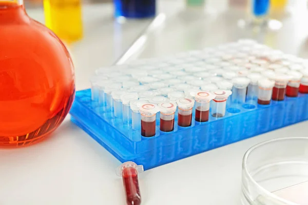 Test tubes with blood on table — Stock Photo, Image
