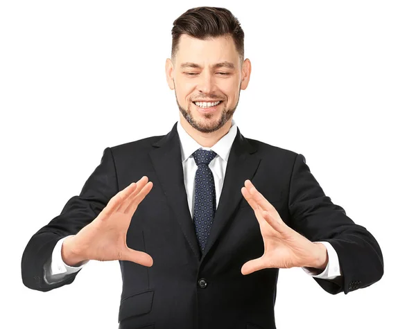 Young businessman holding something on white background — Stock Photo, Image