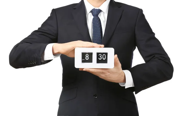 Young businessman holding alarm clock on white background — Stock Photo, Image