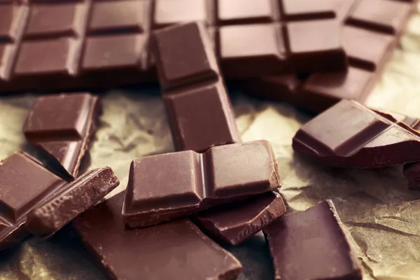 Tasty milk chocolate on table, closeup — Stock Photo, Image