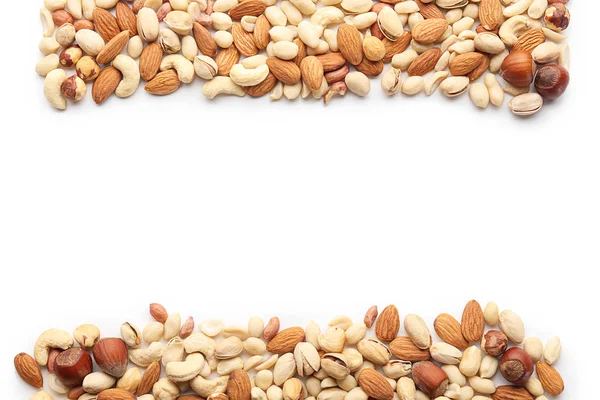 Different types of nuts on white background — Stock Photo, Image