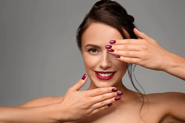 Beautiful young woman with professional manicure on grey background — Stock Photo, Image