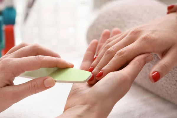 Young woman getting professional manicure in beauty salon, closeup — Stock Photo, Image