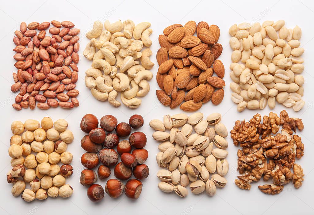 Composition with different types of nuts on white background