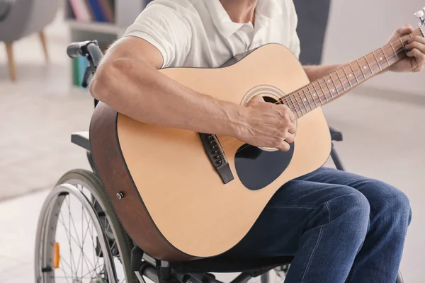 Young musician in wheelchair playing guitar at home — Stock Photo, Image