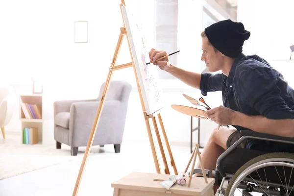 Young artist in wheelchair painting picture at home — Stock Photo, Image