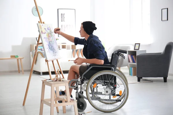 Young artist in wheelchair painting picture at home — Stock Photo, Image