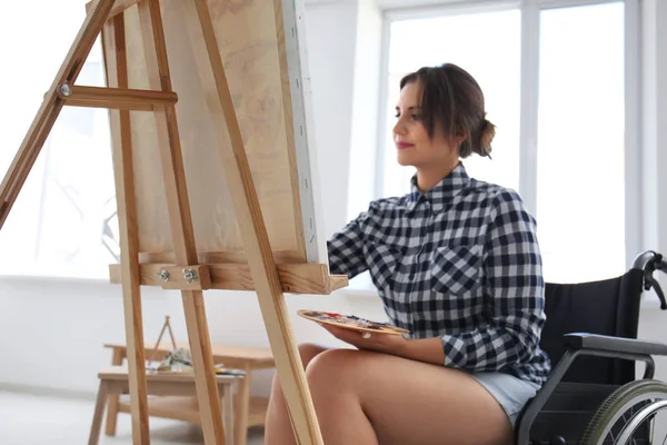 Jeune artiste féminine en fauteuil roulant peinture tableau à la maison — Photo
