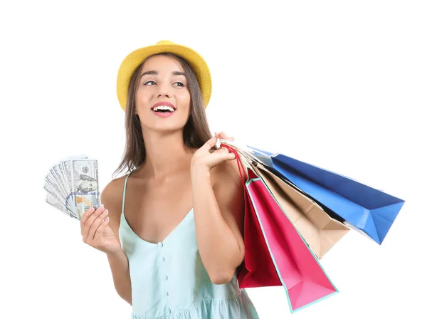 Junge Frau mit Einkaufstaschen und Geld auf weißem Hintergrund — Stockfoto
