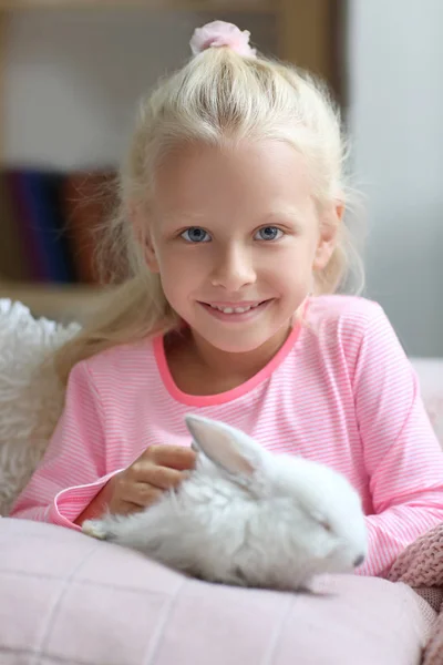 Little girl with cute rabbit at home — Stock Photo, Image