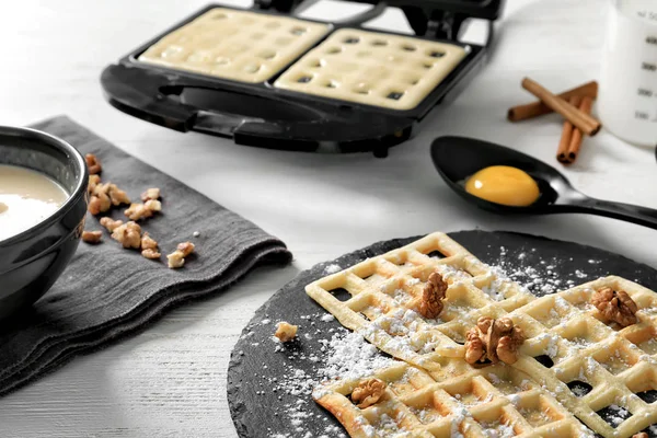 Waffles with ingredients and maker on table — Stock Photo, Image