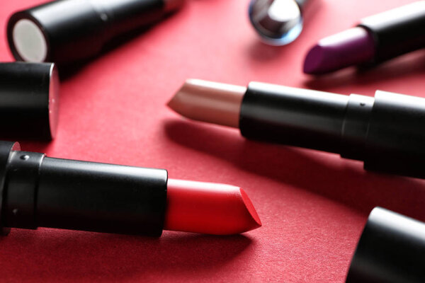 Lipsticks of different shades on color background